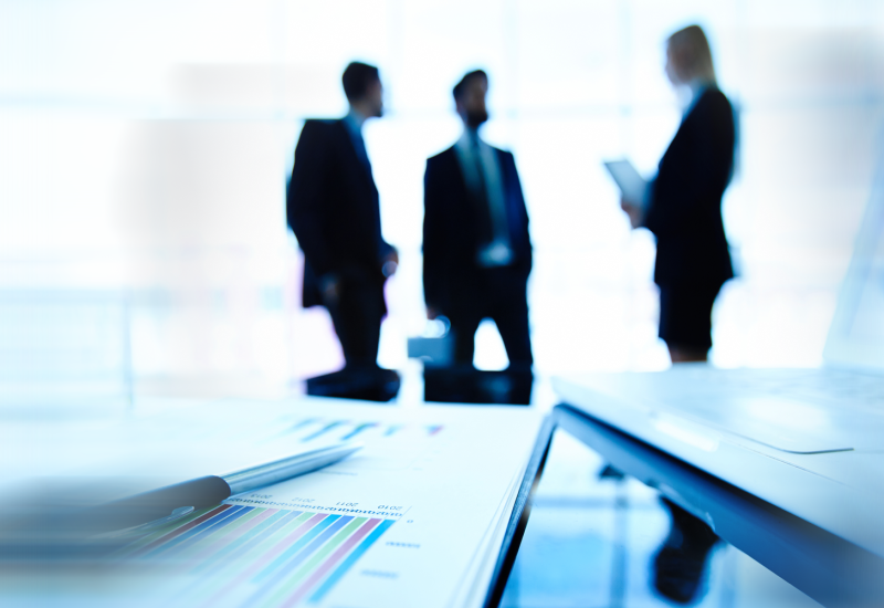 silhouettes-executives-discussing-latest-financial-results